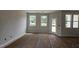 Sun-filled living room features two windows and access to the backyard at 3936 Well Fleet Drive, Fuquay Varina, NC 27526