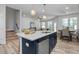 Island kitchen with seating and stainless steel appliances at 3936 Well Fleet Drive, Willow Springs, NC 27592