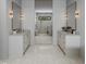 Luxurious bathroom with double vanities, elegant mirrors, and a glass-enclosed shower at 5001 Rampart St, Raleigh, NC 27609