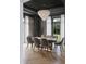Elegant dining room featuring a modern chandelier, neutral color palette, and views of the outdoor greenery at 5001 Rampart St, Raleigh, NC 27609