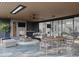 Cozy outdoor patio with a fireplace, comfortable seating, and stylish dining area at 5001 Rampart St, Raleigh, NC 27609