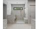 Modern shower room featuring stone wall, glass surround, and golden fixtures at 5001 Rampart St, Raleigh, NC 27609