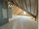 The unfinished attic features exposed wooden beams and a window to let in natural light at 71 Slocum Dr, Wendell, NC 27591