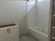 The updated bathroom includes white subway tile, a shower-tub combination and a stylish white vanity at 71 Slocum Dr, Wendell, NC 27591