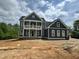 Exterior of a new construction home featuring a balcony, landscaping possibilities, and modern design elements at 71 Slocum Dr, Wendell, NC 27591