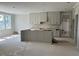 Open-concept kitchen featuring custom cabinets, a center island, and plenty of natural light at 71 Slocum Dr, Wendell, NC 27591