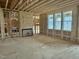 Living room under construction has a corner fireplace and three windows at 71 Slocum Dr, Wendell, NC 27591