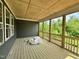 Inviting covered patio with wood ceiling and flooring, overlooking a lush green yard at 71 Slocum Dr, Wendell, NC 27591