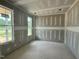 Unfinished room features bare drywall, natural light from windows overlooking trees, ready to be customized at 71 Slocum Dr, Wendell, NC 27591