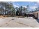 Large backyard with patio, basketball court, and mature trees at 129 Jeffress Dr, Louisburg, NC 27549