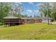 Manicured backyard featuring a home with a screened porch and beautiful landscaping at 129 Jeffress Dr, Louisburg, NC 27549