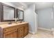 Bathroom with double vanity, framed mirrors, and neutral tiling in a well-lit space at 129 Jeffress Dr, Louisburg, NC 27549