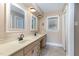 Bathroom featuring double sinks, tiled floors, and a large window for ample natural light at 129 Jeffress Dr, Louisburg, NC 27549