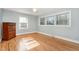 Bright bedroom with hardwood floors and multiple windows providing natural light at 129 Jeffress Dr, Louisburg, NC 27549