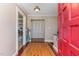 Inviting foyer featuring hardwood floors, a vibrant red door, and a glimpse into the living spaces at 129 Jeffress Dr, Louisburg, NC 27549