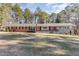Brick ranch house with stone accents, large yard, and mature trees at 129 Jeffress Dr, Louisburg, NC 27549