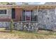 Stone and brick front entrance with red door and small porch at 129 Jeffress Dr, Louisburg, NC 27549