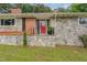 A closer view of the stone porch with black railings and a vibrant red front door at 129 Jeffress Dr, Louisburg, NC 27549