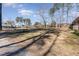 Spacious front yard with mature trees and a gravel driveway at 129 Jeffress Dr, Louisburg, NC 27549