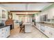 Bright kitchen featuring an island with seating, granite countertops, and a seamless flow to dining area at 129 Jeffress Dr, Louisburg, NC 27549