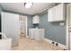 Functional laundry room with tile floors, white cabinets, and included washer and dryer at 129 Jeffress Dr, Louisburg, NC 27549