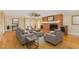 Cozy living room featuring a brick fireplace, wood floors, and neutral-toned furniture for a relaxing atmosphere at 129 Jeffress Dr, Louisburg, NC 27549