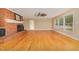 Bright living room features a brick fireplace, hardwood floors, and natural light from the large windows at 129 Jeffress Dr, Louisburg, NC 27549