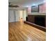 Open concept living room with hardwood floors and an original brick fireplace at 129 Jeffress Dr, Louisburg, NC 27549