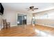 Well-lit living room with hardwood floors, sliding door to patio, and neutral wall color at 129 Jeffress Dr, Louisburg, NC 27549