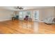 Bright living room with hardwood floors, large windows, and comfortable seating at 129 Jeffress Dr, Louisburg, NC 27549