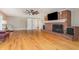 Spacious living room featuring hardwood floors, a brick fireplace, and ample natural light at 129 Jeffress Dr, Louisburg, NC 27549