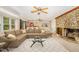 Spacious living room with stone fireplace, bar seating, and comfortable seating area at 129 Jeffress Dr, Louisburg, NC 27549