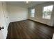 Bright bedroom with hardwood floors and two large windows at 1309 Hazelnut Ridge Ln, Knightdale, NC 27545