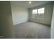 Bright bedroom with large window and grey carpet at 1309 Hazelnut Ridge Ln, Knightdale, NC 27545
