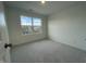 Bright bedroom with large window and grey carpet at 1309 Hazelnut Ridge Ln, Knightdale, NC 27545