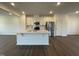Modern kitchen with white cabinets, stainless steel appliances, and island at 1309 Hazelnut Ridge Ln, Knightdale, NC 27545