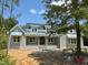 Charming exterior of a home with stone accents, complemented by a well-manicured lawn and inviting entrance at 172 Quail Pt, Pittsboro, NC 27312