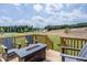 Relaxing deck with fire pit and scenic backyard view at 239 Circle City Way, Pittsboro, NC 27312