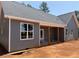 Gray home with a covered porch and large windows at 2850 Sheep Pasture Rd, Spring Hope, NC 27882