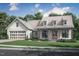 Finished exterior of a house with a two-car garage, dormer windows, a sidewalk and a landscaped yard at 2850 Sheep Pasture Rd, Spring Hope, NC 27882