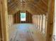 Interior attic view showcasing framed structure with small window, unfinished space with potential at 2850 Sheep Pasture Rd, Spring Hope, NC 27882