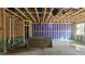 Unfinished room shows open ceiling framework and natural light from window at 3934 Well Fleet Drive, Fuquay Varina, NC 27526