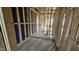 An unfinished room featuring wood framing, plumbing, and open access to another room at 3934 Well Fleet Drive, Fuquay Varina, NC 27526