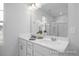 Bathroom with double sinks, modern fixtures, and a large mirror at 3934 Well Fleet Drive, Fuquay Varina, NC 27526