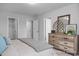 Neutral bedroom with a dresser, closet, and two doors at 3934 Well Fleet Drive, Fuquay Varina, NC 27526