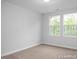 This bedroom has carpet flooring, is painted in light colors, and has two windows at 3934 Well Fleet Drive, Fuquay Varina, NC 27526