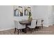 Elegant dining room with dark wood table, neutral chairs, and modern artwork at 3934 Well Fleet Drive, Fuquay Varina, NC 27526