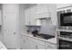 Well-equipped kitchen with gray backsplash, stainless appliances, and white cabinets at 3934 Well Fleet Drive, Fuquay Varina, NC 27526