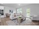 Cozy living room with neutral tones, a stylish rug, and ample seating at 3934 Well Fleet Drive, Fuquay Varina, NC 27526