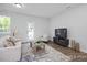 Cozy living room featuring a comfortable sofa, coffee table, and neutral decor at 3934 Well Fleet Drive, Fuquay Varina, NC 27526